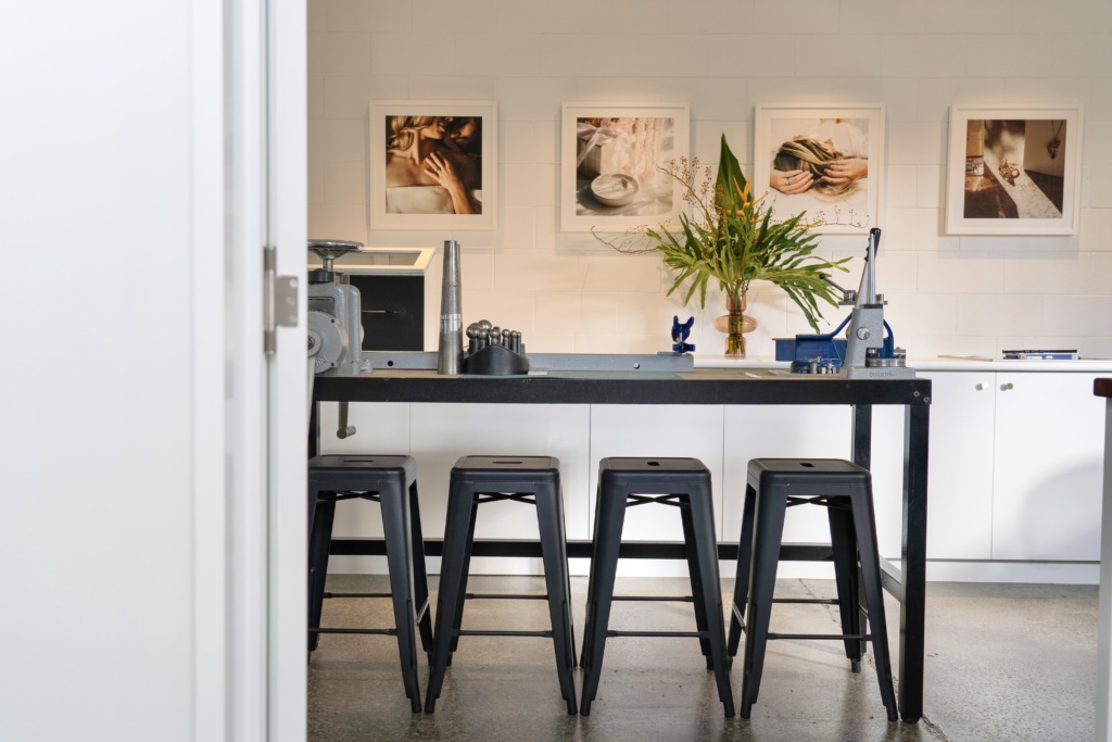 interior designer hanging framed artwork in space