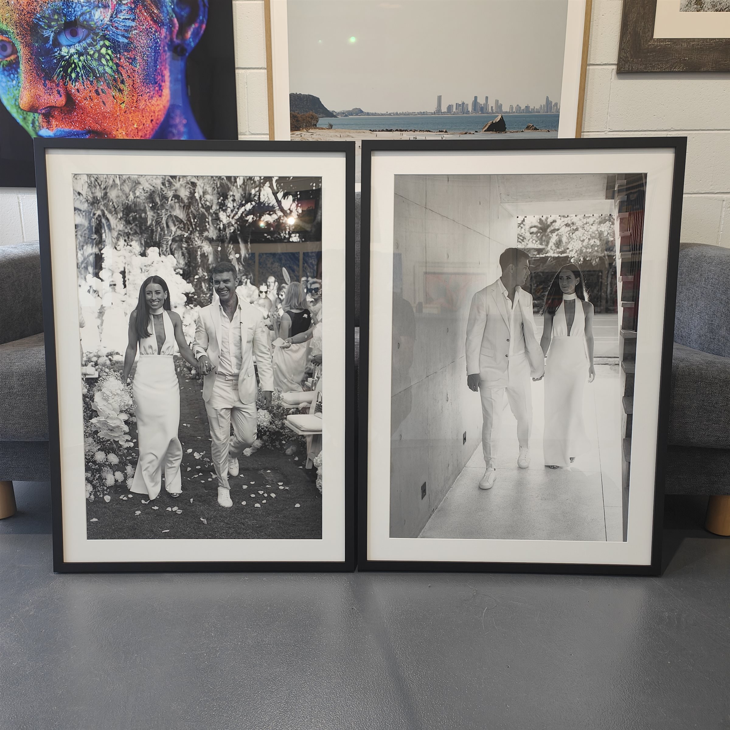 Black and white wedding portraits in black timber frames with white mats in the Burleigh Heads showroom
